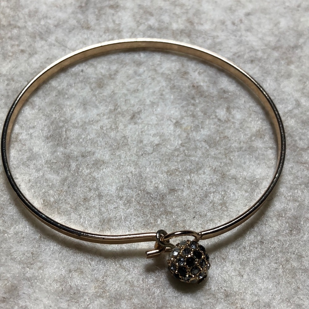 Gold bangle bracelet with rhinestone clasp